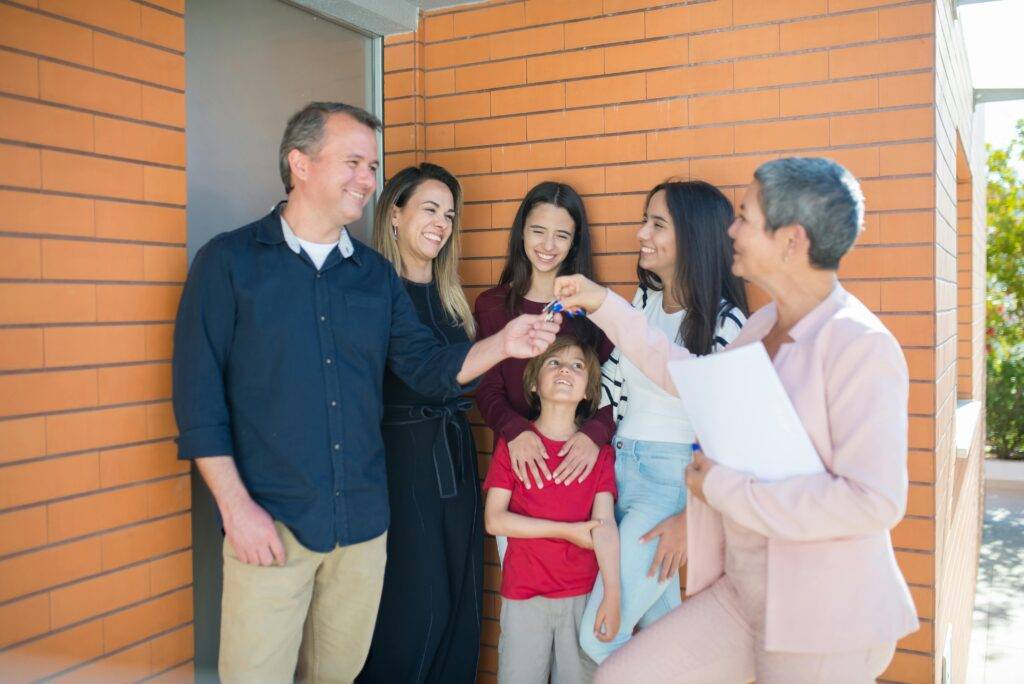 Happy family which just purchased an affordable house Low income housing built with Gemite modular systems.